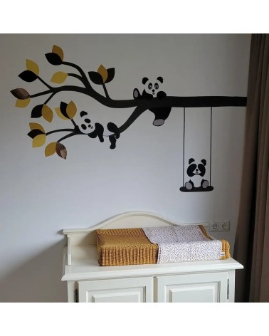 Behang muursticker boom met schattige pandabeertjes in verschillende okergele tinten, geplakt boven de commode in de babykamer.