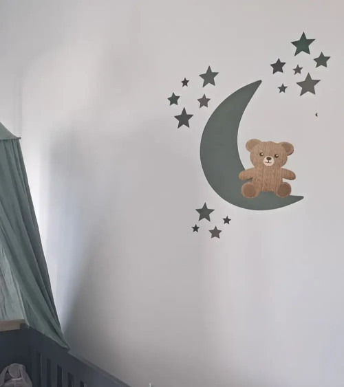 Behangsticker jongens babykamer zittend teddybeertje op een lichtblauwe maan met sterren.