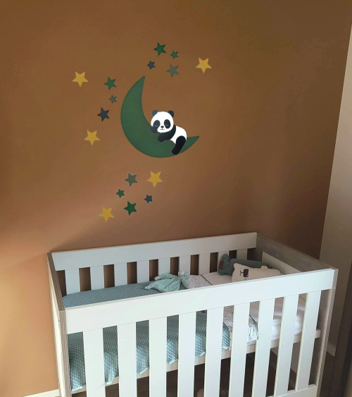 Babykamer behangsticker met een slapende pandabeer op een donkergroene maan.