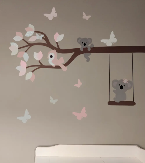Muurdecoratie meisjeskamer boomtak met diertjes in pastel kleuren.
