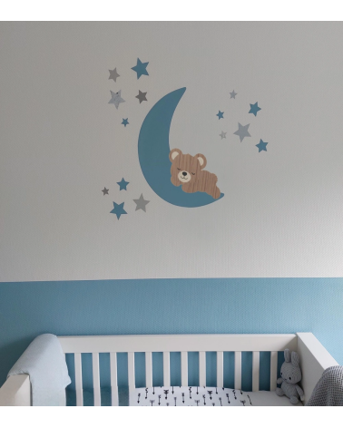Muursticker babykamer slapende teddybeer op een lichtblauwe maan met sterren.